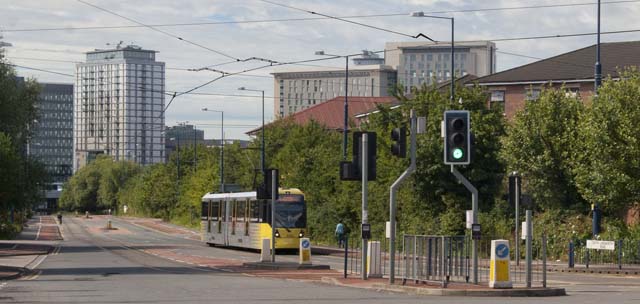 Metrolink tram passing Quays Reach, with MediaCityUK (Salford) in the background
